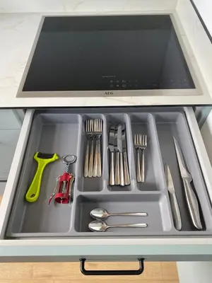 a tray filled with utensils in a drawer at Šiauliai CENTER Višinskio NEW self check In in Šiauliai