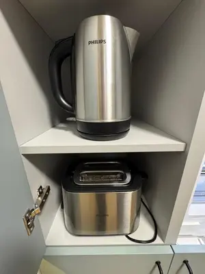 a coffeemaker sitting on a shelf in a kitchen at Šiauliai CENTER Višinskio NEW self check In in Šiauliai