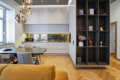 a kitchen and dining room with a table and chairs at Forentinn Gedimino pr. in Vilnius