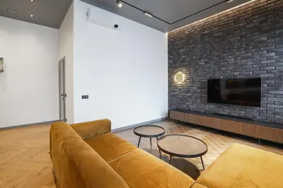 a living room with a couch and two tables and a tv at Forentinn Gedimino pr. in Vilnius