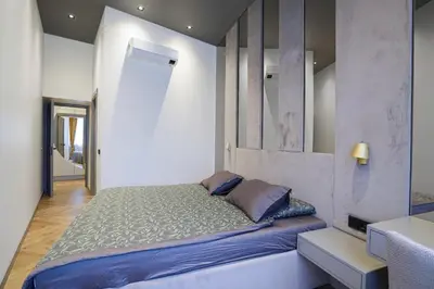 a bedroom with a large bed in a room at Forentinn Gedimino pr. in Vilnius