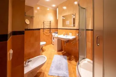 a bathroom with a sink and a toilet and a shower at HaPPy Inn ArkA the heart of Old Town, Self-Check-in, A-C, Car-Parking, Balkony in Vilnius