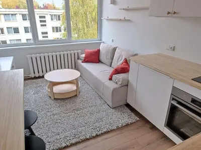 a living room with a white couch and a table at Stylish Studio in Central Vilnius II in Vilnius