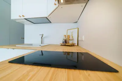 a living room with a sink and a table at Stylish Studio in Central Vilnius II in Vilnius