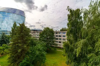 a view of a building and trees in a city at Stylish Studio in Central Vilnius II in Vilnius