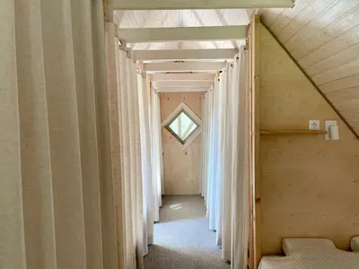 a hallway of a house with curtains and a window at Holiday homestead Camp of Forest Souls in Masališkės