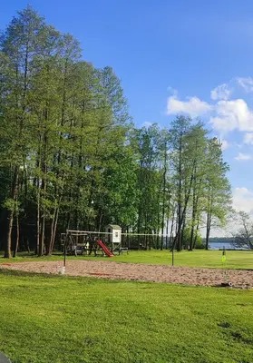 a park with a playground with a swing at Perlytė in Metelyte