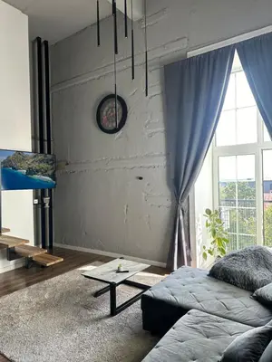 a living room with a couch and a table at Radio City loft - apartment 420 in Kaunas