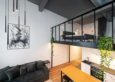 a living room with a couch and a loft bed at Radio City loft - apartment 420 in Kaunas