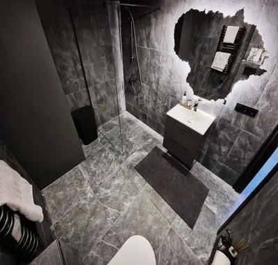 a bathroom with a sink and a mirror at Radio City loft - apartment 420 in Kaunas