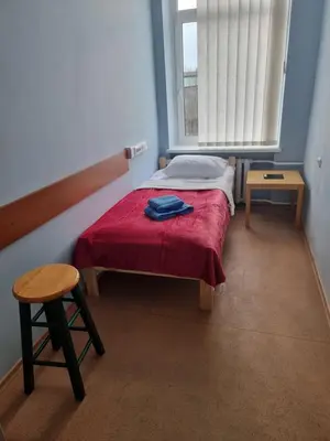 a small bedroom with a bed and a window at Apgyvendinimo įstaiga KORNEALITA in Zarasai