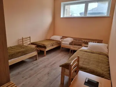 a room with three beds and a window at Apgyvendinimo įstaiga KORNEALITA in Zarasai