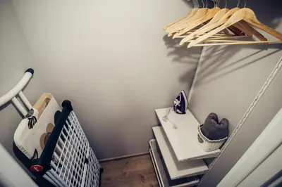 a baby room with a crib and a table at Pine Apartment in Visaginas