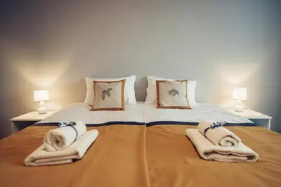 a bedroom with a large bed with towels on it at Pine Apartment in Visaginas