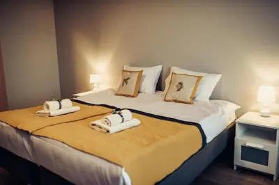 a bedroom with two beds with towels on them at Pine Apartment in Visaginas