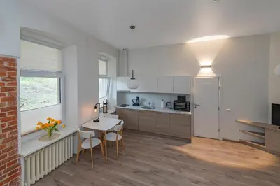 a kitchen with a table and chairs in a room at Freedom Avenue Apartment by Polo apartments in Kaunas