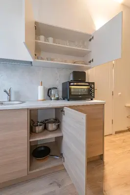 a kitchen with a sink and a counter with a microwave at Freedom Avenue Apartment by Polo apartments in Kaunas
