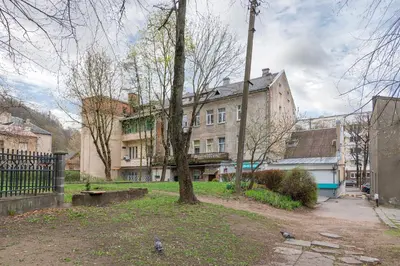 a building with a tree in the middle of a park at Freedom Avenue Apartment by Polo apartments in Kaunas
