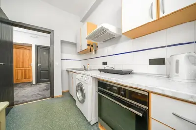 a kitchen with a dishwasher and a washer at Capital's Old Town Gem in Vilnius