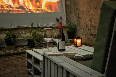 a bottle of wine and two wine glasses on a table at Capital's Old Town Gem in Vilnius