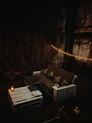 a room with a couch and a table and lights at Capital's Old Town Gem in Vilnius