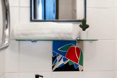 a bathroom sink with a mirror and a towel at Capital's Old Town Gem in Vilnius