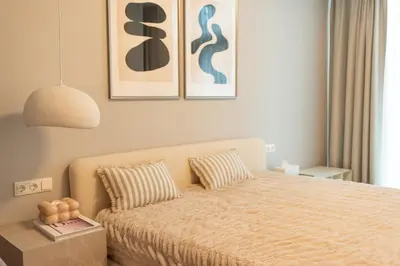 a bedroom with a bed and two paintings on the wall at Home in in Druskininkai