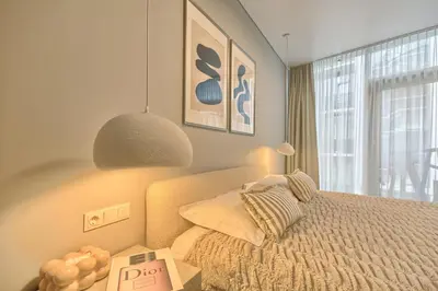 a bedroom with a bed and a large window at Home in in Druskininkai