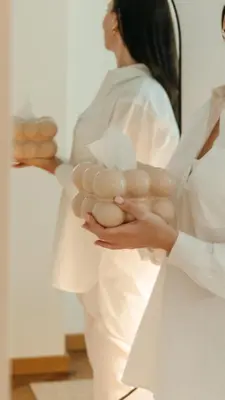 a woman in white holding a bunch of eggs at Home in in Druskininkai