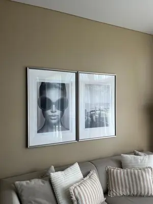three pictures on a wall above a couch at Home in in Druskininkai