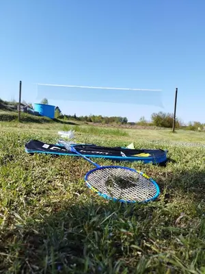 two tennis rackets laying on the grass in a field at Poilsis netoli Druskininkų in Druskininkai