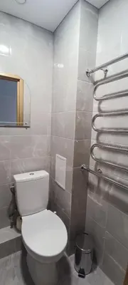 a bathroom with a white toilet and a mirror at Adomo Apartamentai Panevėžyje in Panevėžys