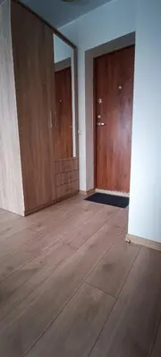 an empty room with two doors and a wooden floor at Adomo Apartamentai Panevėžyje in Panevėžys