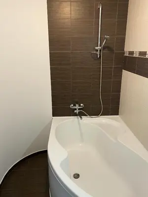 a bathroom with a white tub and a shower at 