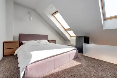a bedroom with a large bed in a attic at Charming Loft in Vilnius Oldtown in Vilnius