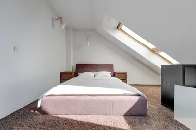 a bedroom with a bed in a attic at Charming Loft in Vilnius Oldtown in Vilnius