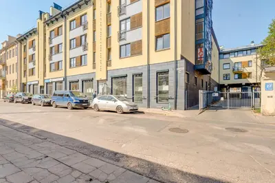 a row of cars parked in front of a building at Charming Loft in Vilnius Oldtown in Vilnius