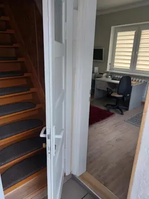 an open door leading to an office with a staircase at Kotedžas nuomai - Retro 70, Šiauliai in Šiauliai