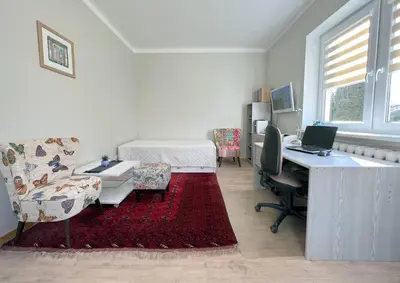 a bedroom with a desk and a bed and a desk with a computer at Kotedžas nuomai - Retro 70, Šiauliai in Šiauliai