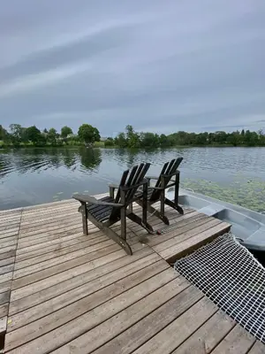 two chairs sitting on top of a dock on a boat at Island House atostogų namai in Gaylyunay