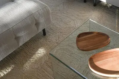 a glass coffee table with a wooden seat next to a couch at Island House atostogų namai in Gaylyunay