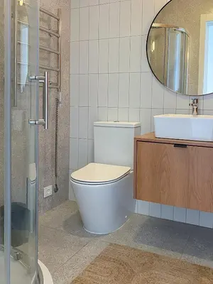 a bathroom with a toilet and a sink and a mirror at Island House atostogų namai in Gaylyunay