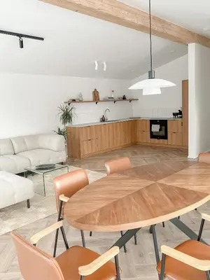 a living room with a table and a couch at Island House atostogų namai in Gaylyunay