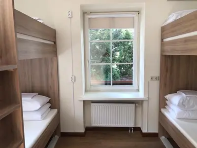 a room with two beds and a window at Bed&Blues in Vilnius