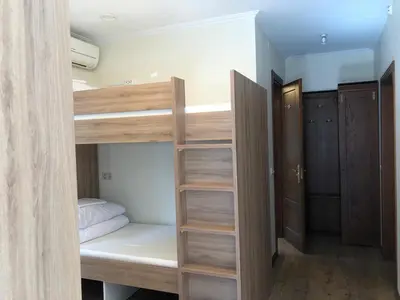 a room with two bunk beds and a closet at Bed&Blues in Vilnius