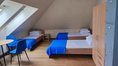a attic room with two beds and a table at Bed&Blues in Vilnius
