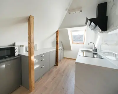 a kitchen with white counter tops and a sink at Petro studija in Kaunas