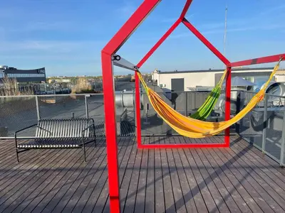 a deck with a hammock and a bench at Center stay Kaunas - Peledyne - Owl's nest apartments in Kaunas