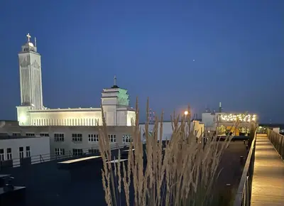 a view of a city at night with a building at Center stay Kaunas - Peledyne - Owl's nest apartments in Kaunas