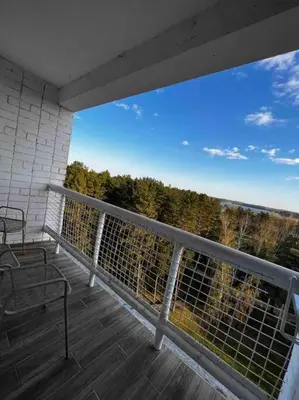 a balcony with a bench and a view of trees at Studio Apartment with Lake View in Visaginas